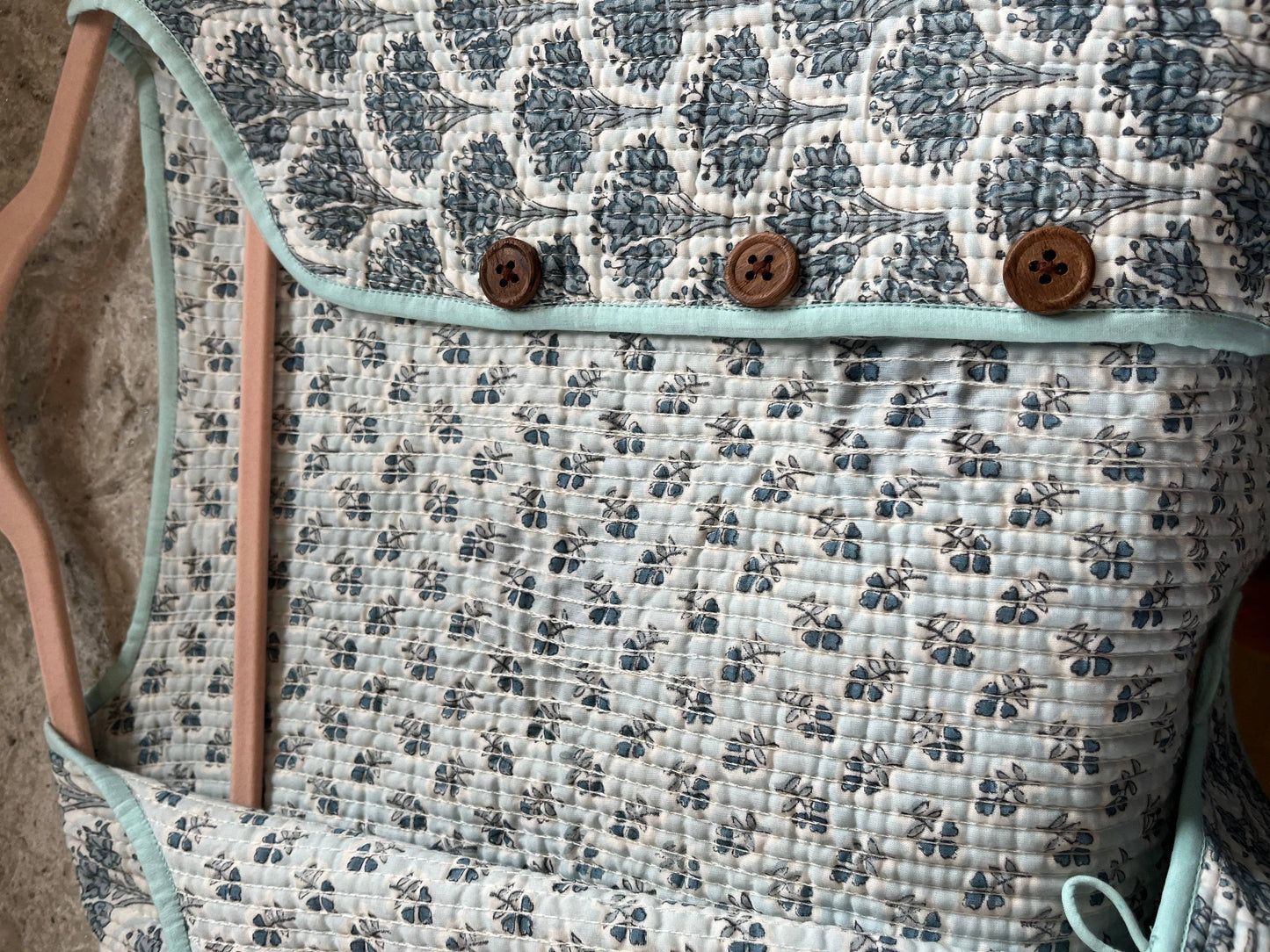 Wood block printed cotton quilted reversible jacket in soft blues.