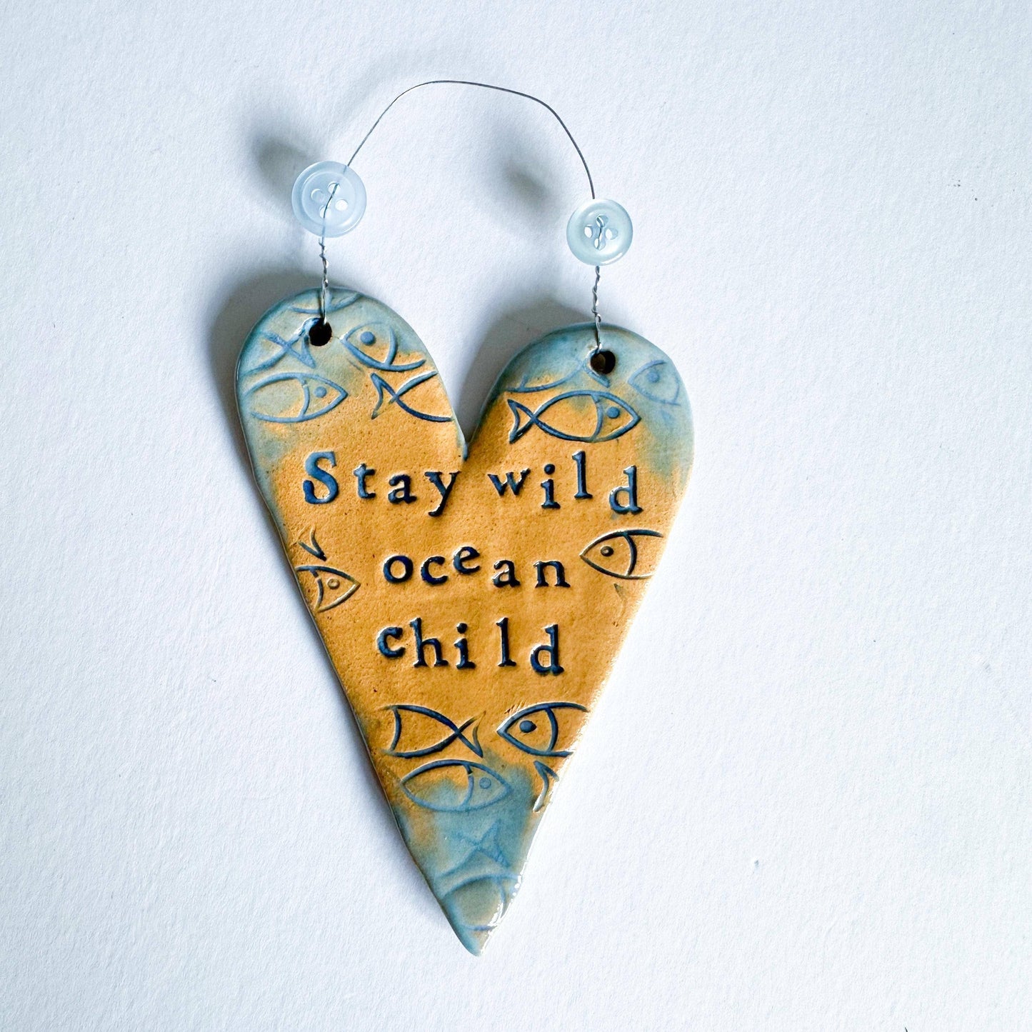 Stay Wild Ocean Child ceramic hanging heart. Made in Wales.