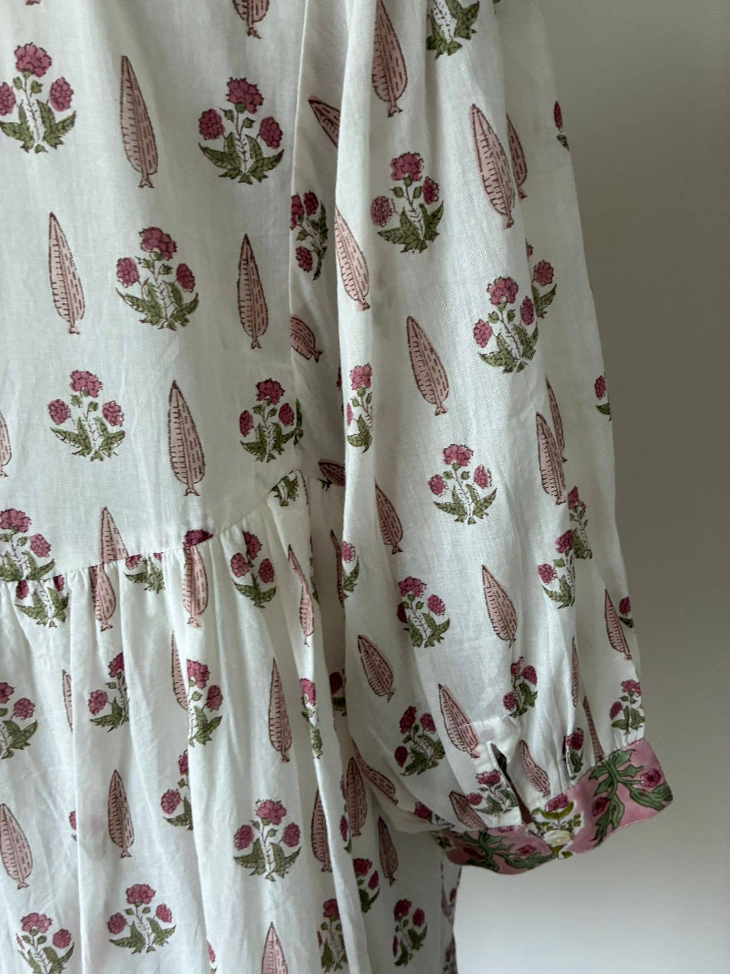 Wood block printed cotton voile dress in soft cream and pink .