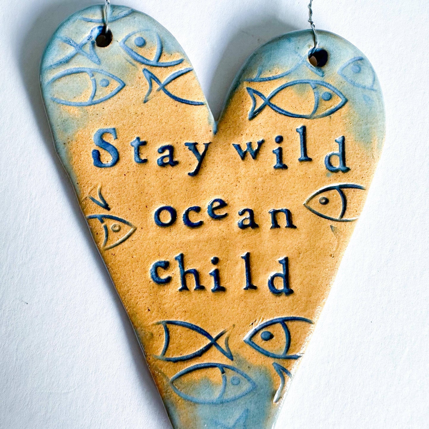 Stay Wild Ocean Child ceramic hanging heart. Made in Wales.
