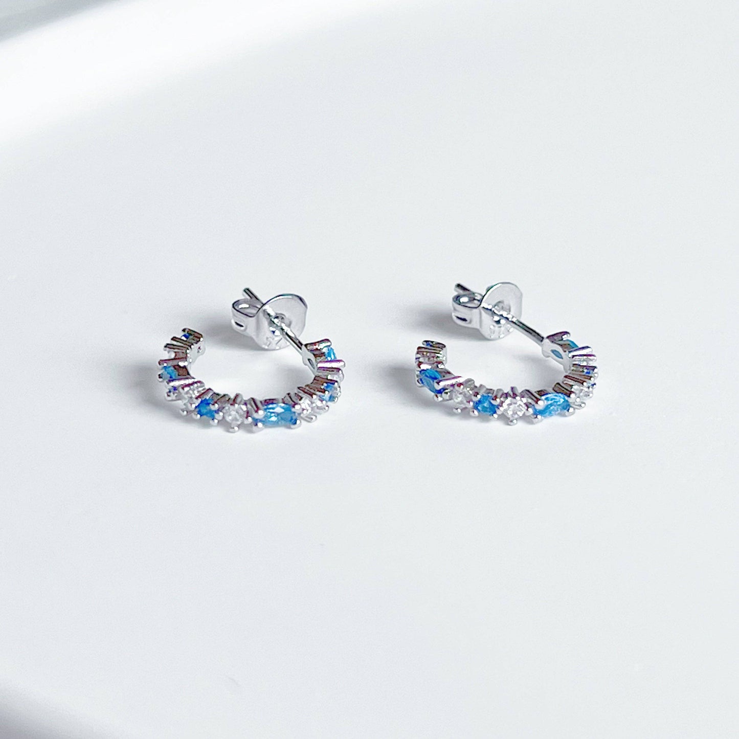 Ninaouity - Silver Blue Topaz Mini Hoop Earrings - December Birthstone