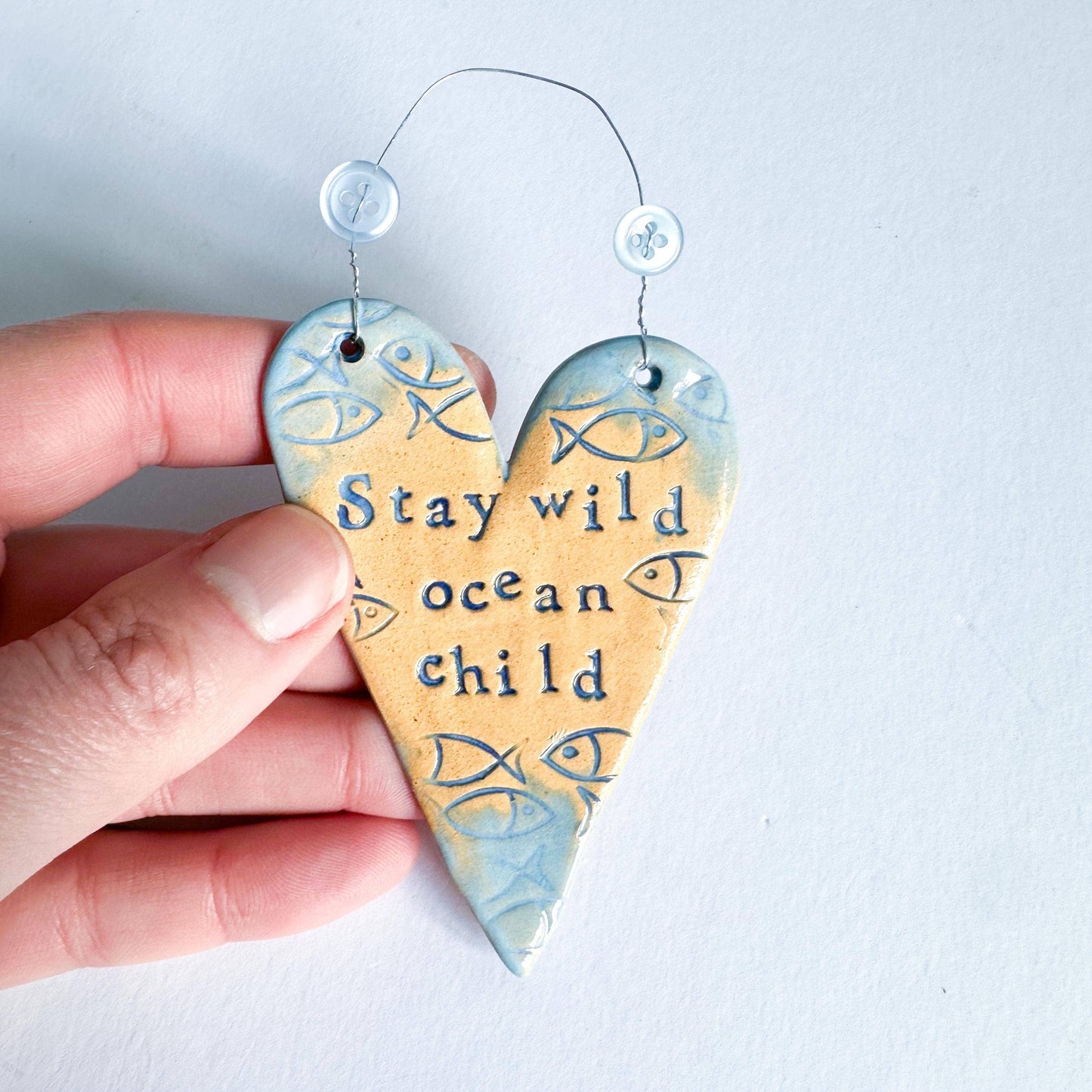 Stay Wild Ocean Child ceramic hanging heart. Made in Wales.