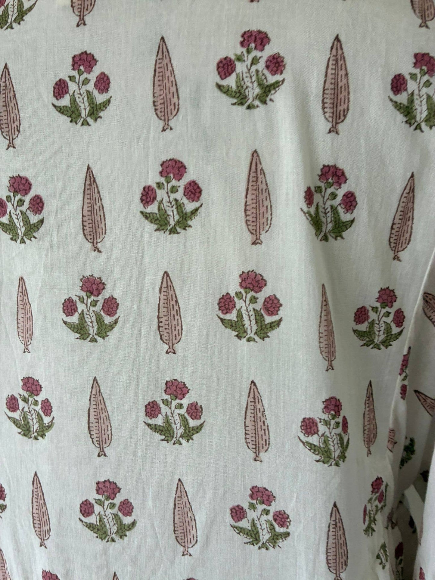 Wood block printed cotton voile dress in soft cream and pink .